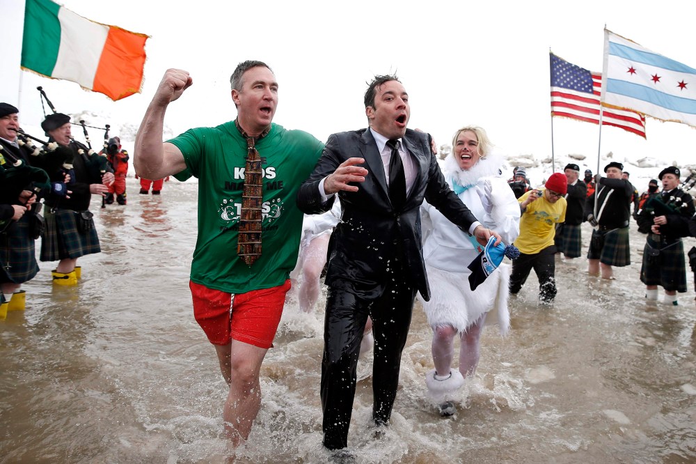 "The Tonight Show" host Jimmy Fallon (C) emerges from the waters of Lake Michigan as he takes part in the Annual Polar Plunge in Chicago, March 2, 2014.
