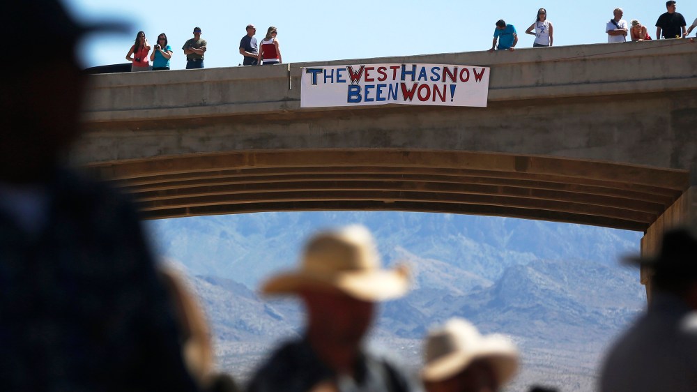 Image: Protesters place a sign on a bridge near the Bureau of Land Management 's base camp where seized cattle, that belonged to rancher Cliven Bundy, are being held at near Bunkerville