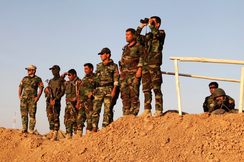 Kurdish peshmerga troops keep watch during an intensive security deployment against Islamic State militants on the frontline in Khazer August 14, 2014.