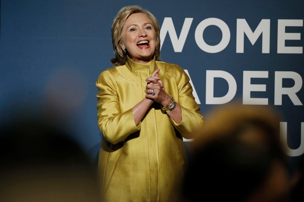 Former U.S. Secretary of State Hillary Clinton reacts to the cheers of the crowd as she arrives to address the Democratic National Committee's Women's Leadership Forum annual Issues Conference in Washington, Sept. 19, 2014.