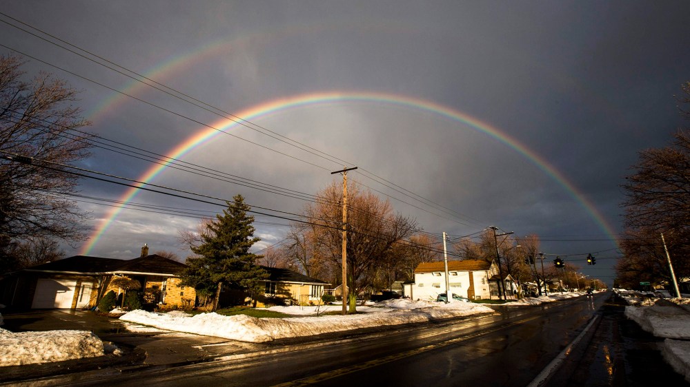 A rainbow forms over a neighbourhood following a massive snow storm in West Seneca, New York on Nov. 24, 2014