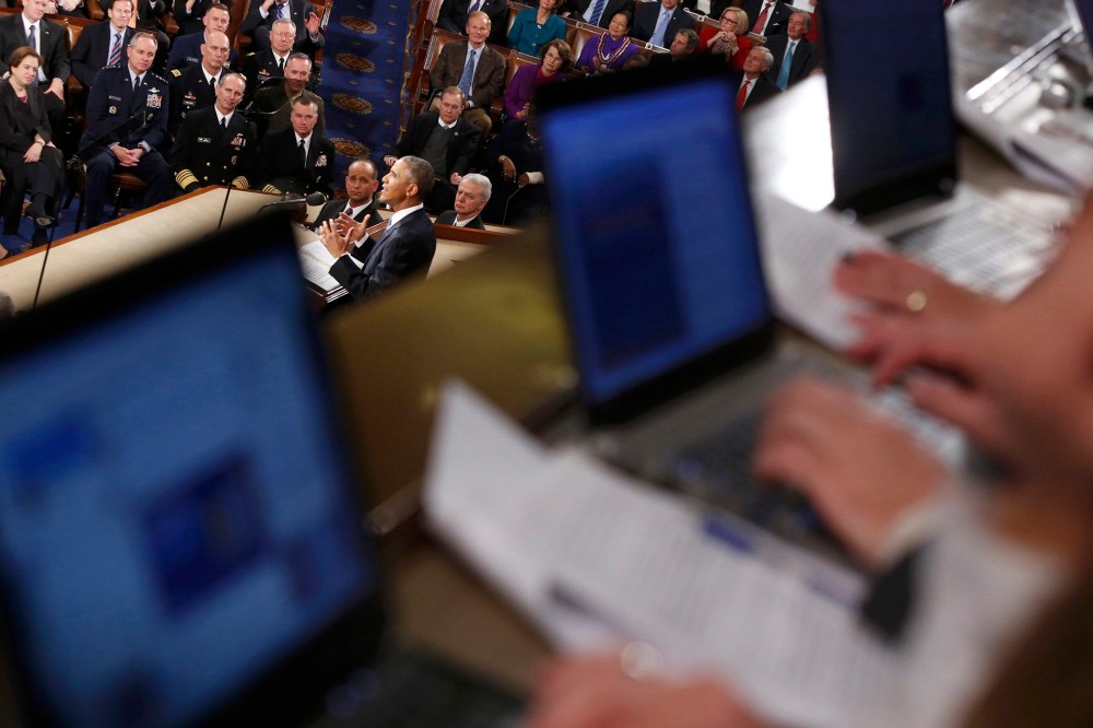 Reporters write their stories on their computers in the gallery as U.S. President Barack Obama delivers his State of the Union address to a joint session of the U.S. Congress on Capitol Hill in Washington, Jan. 20, 2015. (Photo by Jonathan Ernst/Reuters)
