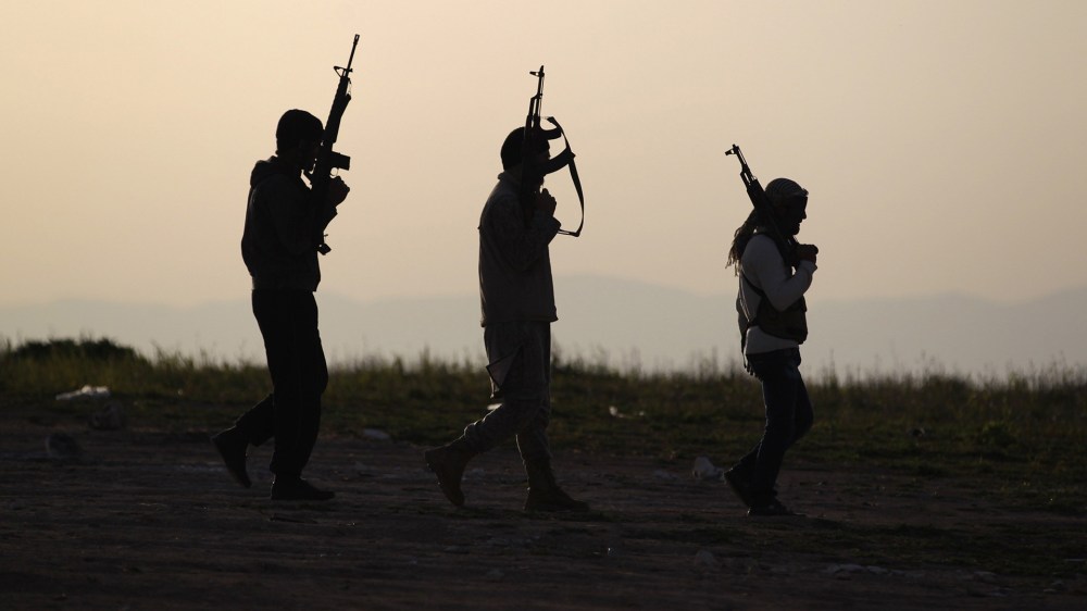 Free Syrian Army fighters carry their weapons as they walk on a frontline in Mork, Syria on March 8, 2015. (Photo by Khalil Ashawi/Reuters)