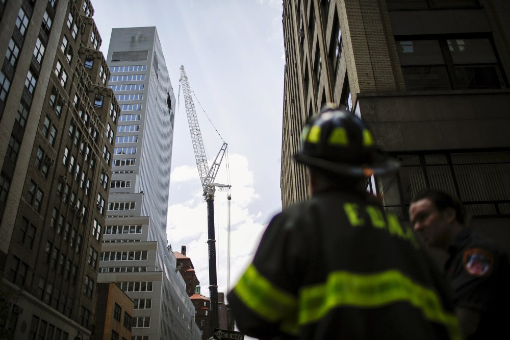 New York Fire Department members attend an emergency response after the cable of the crane snapped on a building in New York, N.Y., May 31, 2015. (Photo by Eduardo Munoz/Reuters)