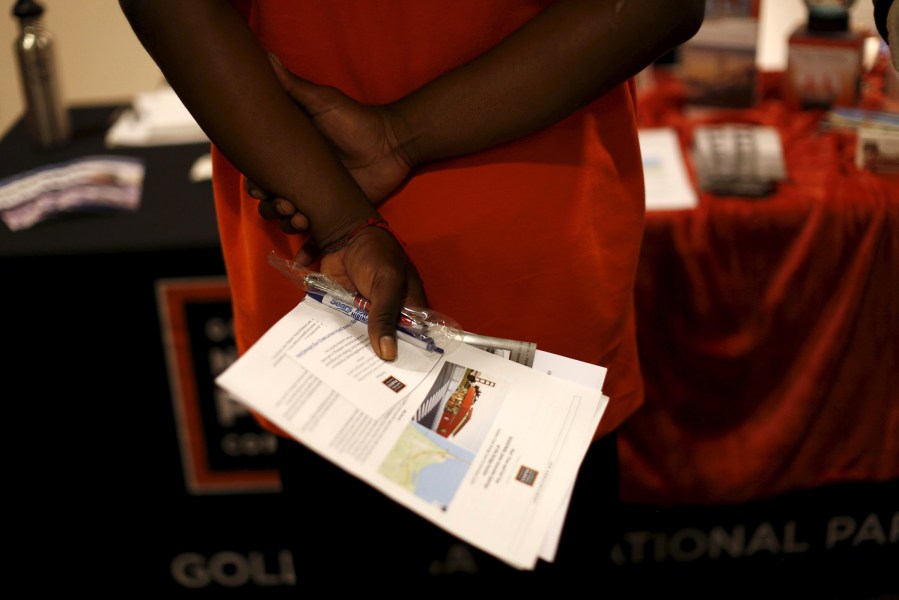 A job seeker holds literature while waiting to speak with a representative of the Golden Gate National Parks Conservancy at a career fair in San Francisco, Calif., July 14, 2015. (Photo by Robert Galbraith/Reuters)