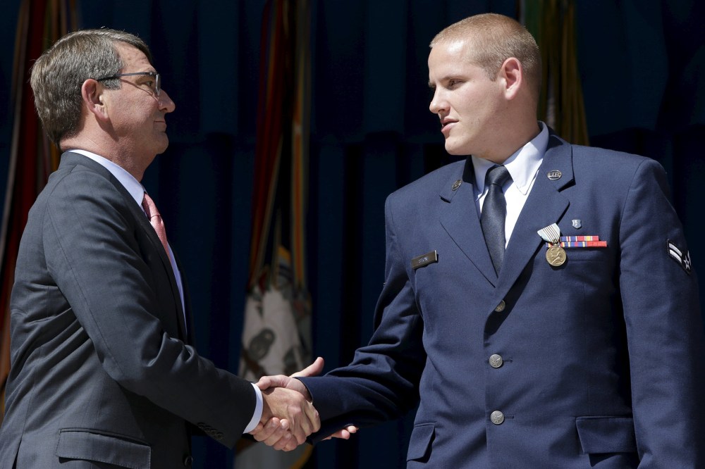 Secretary of State Carter shakes the hand of Airman Stone during medal ceremony (Photo by Gary Cameron/Reuters)