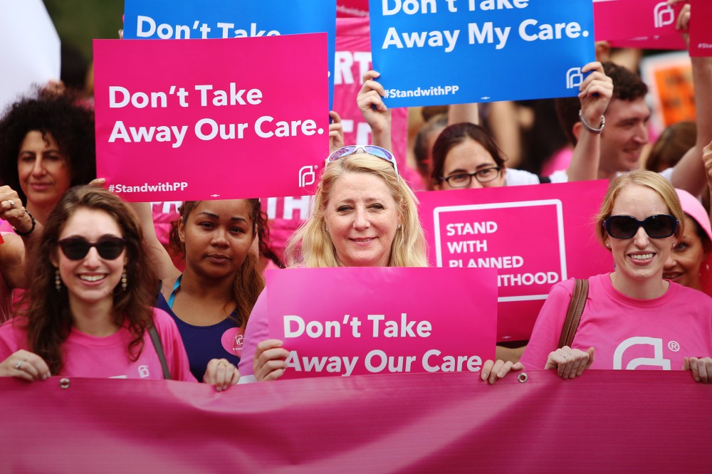 Pro-choice protesters hold pink Planned Parenthood banner and signs in Foley Square, New York, Sept. 29, 2015. (Photo by Andy Katz/Pacific Press/ZUMA)
