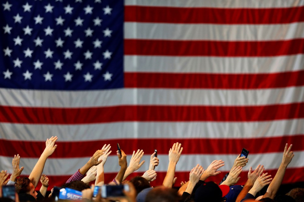 Supporters wave their hands in unison as they gather at a rally for Democratic presidential candidate Bernie Sanders in Anaheim, Calif., May 24, 2016. (Photo by Mike Blake/Reuters)