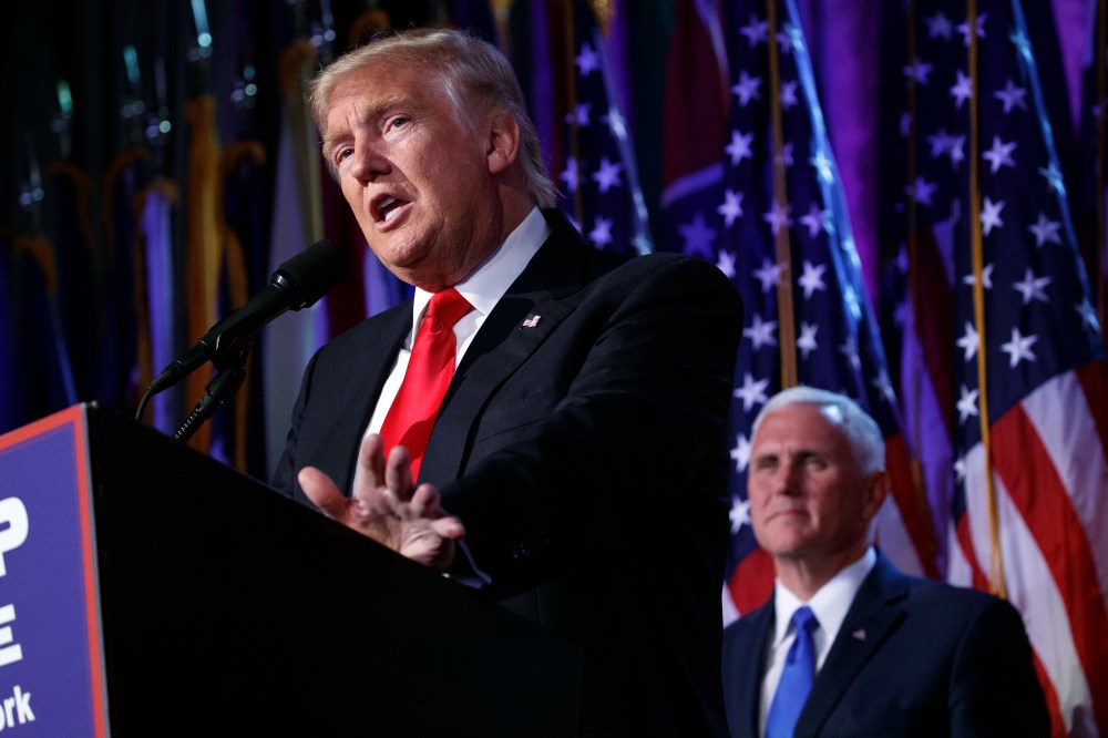 Vice president-elect Mike Pence, watches as President-elect Donald Trump speaks during an election night rally, Nov. 9, 2016, in N.Y. (Photo by Evan Vucci/AP)