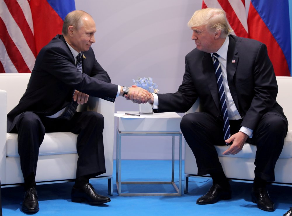 Image: FILE PHOTO: U.S. President Donald Trump shakes hands with Russia's President Vladimir Putin during the their bilateral meeting at the G20 summit in Hamburg
