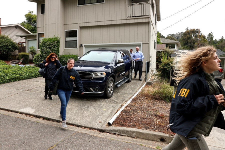 FBI agents exit a home associated with Oakland Mayor Sheng Thao during a raid in Oakland, Calif., on June 20, 2024.