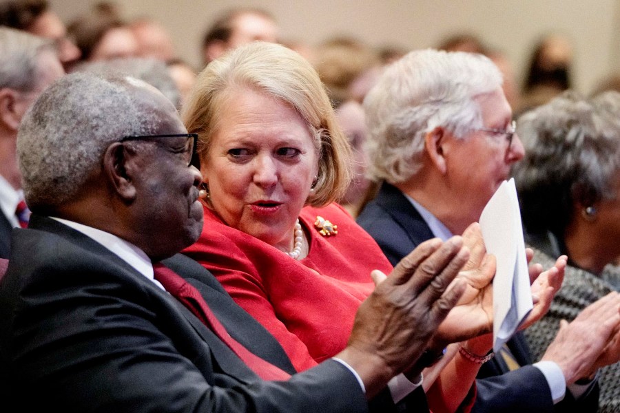 Associate Supreme Court Justice Clarence Thomas sits with his wife and conservative activist Virginia 