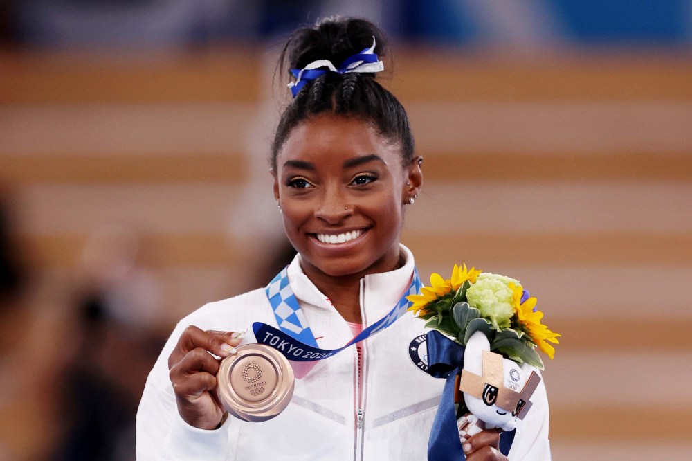 Simone Biles poses with the bronze medal during the Women's Balance Beam Final medal ceremony at the Tokyo 2020 Olympic Games on Aug. 3, 2021.