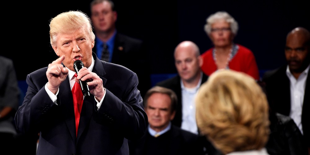 Image: Donald Trump speaks as Hillary Clinton looks on during a town hall debate.