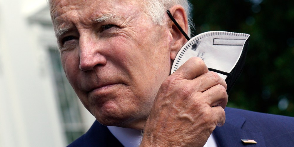 Image: President Joe Biden removes his mask.