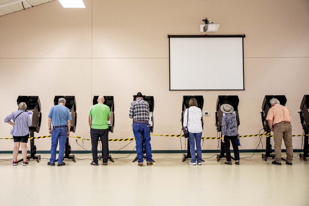 Voters cast ballots at a polling location at North Christian Church in Cheyenne, Wyo. on Aug. 16.