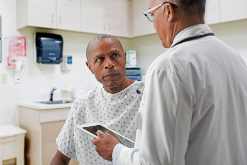 Doctor talking to patient in office.