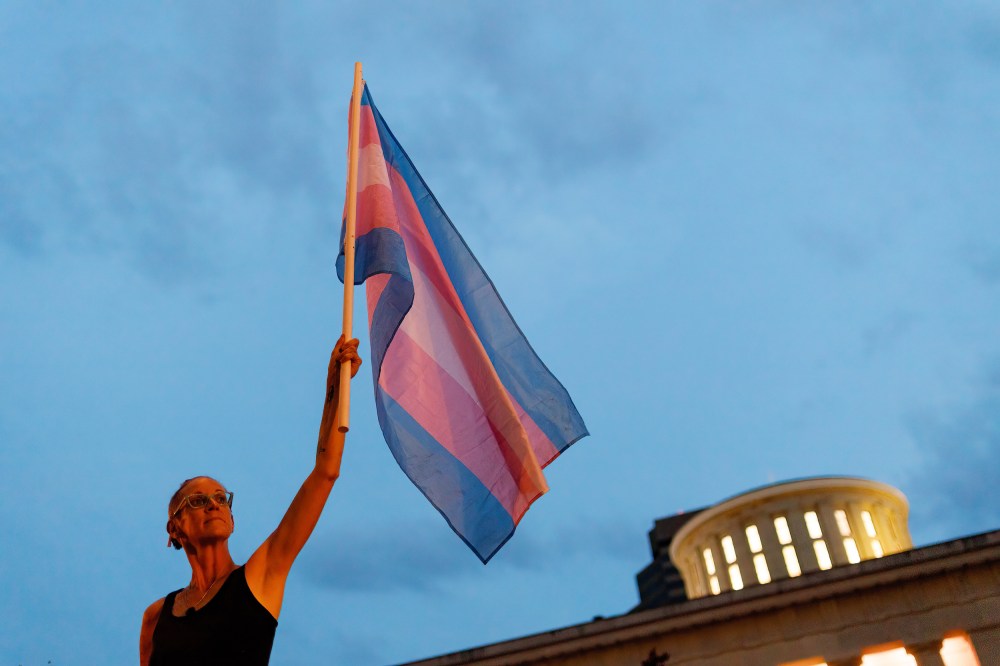 A transgender rights advocate  outside of the statehouse to oppose an amendment to a bill to ban transgender women from participating in high school and college women sports in Columbus, Ohio,
