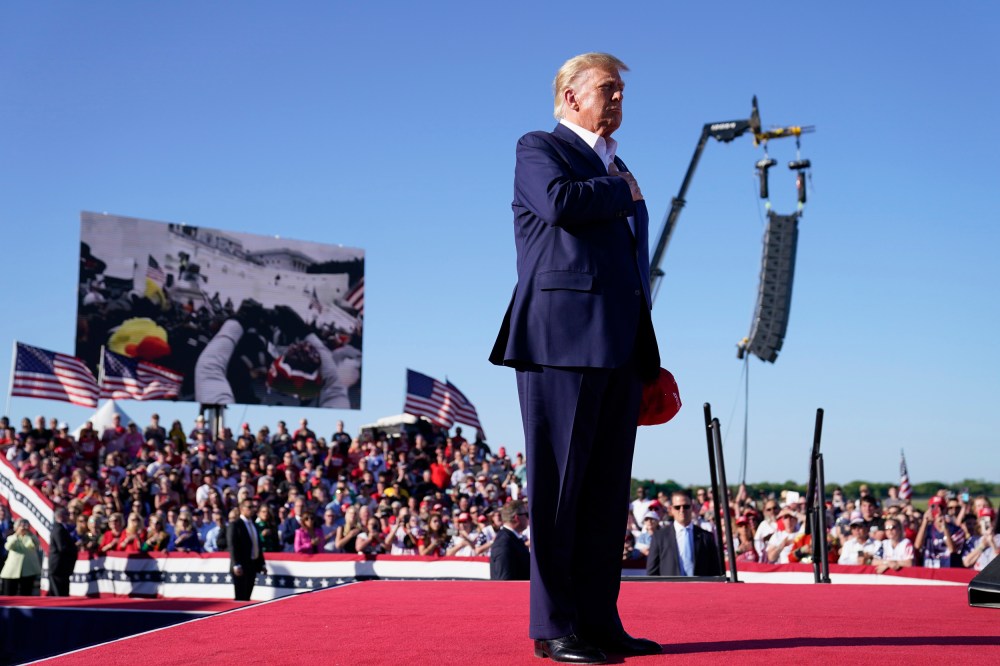 Donald Trump stands while "Justice for All," is played during a campaign rally, in Waco, Texas