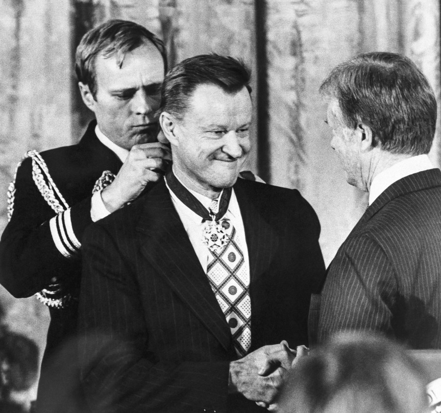 President Jimmy Carter shakes hands with his national security adviser Zbigniew Brzezinski as he presents Brzezinski with the Medal of Freedom at a White House ceremony on Jan. 17, 1981.