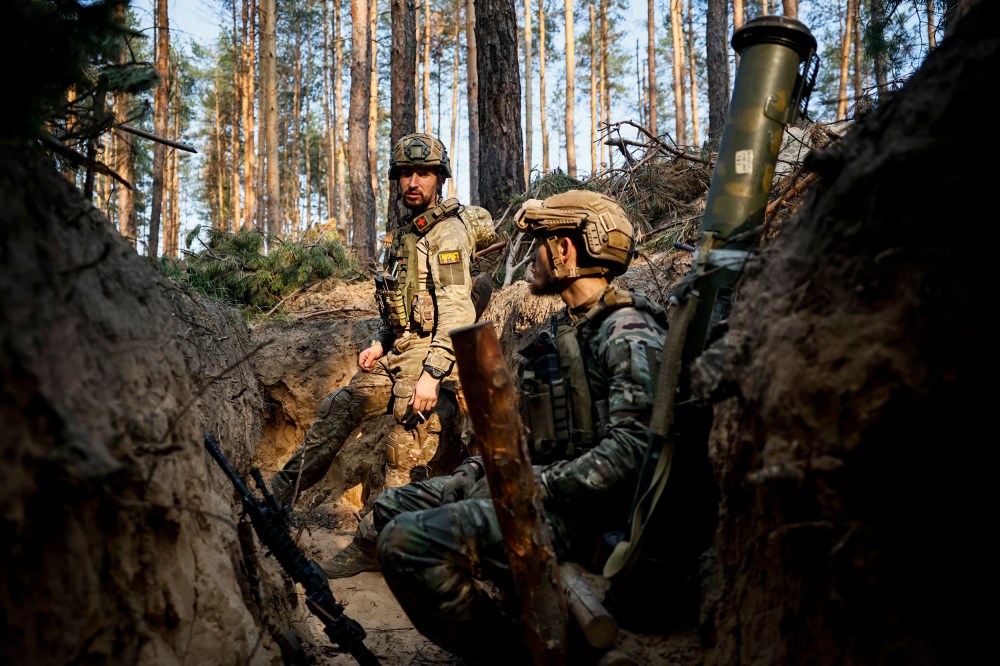 Ukrainian soldiers rest in a trench on the frontline near Kreminna, Luhansk region, on June 8, 2023.