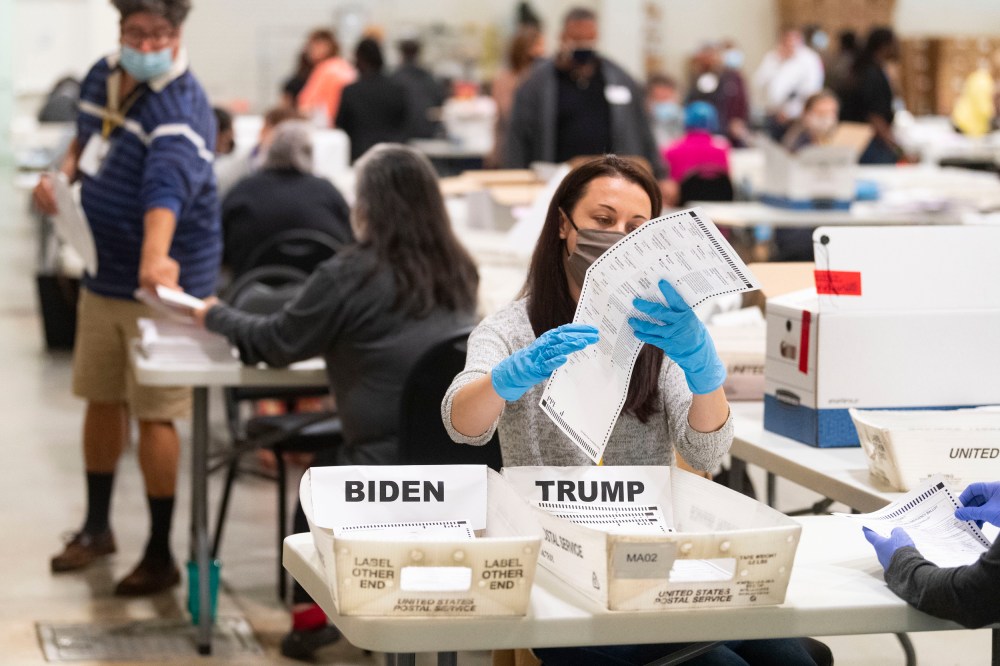 An election worker looks at a ballot during a Cobb County hand recount of Presidential votes in Marietta, Ga.