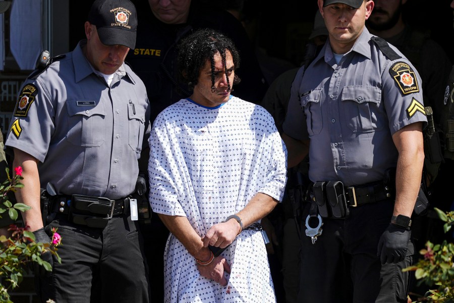 Law enforcement officers escort Danelo Cavalcante from a Pennsylvania State Police barracks in Avondale Pa., on Sept. 13, 2023.
