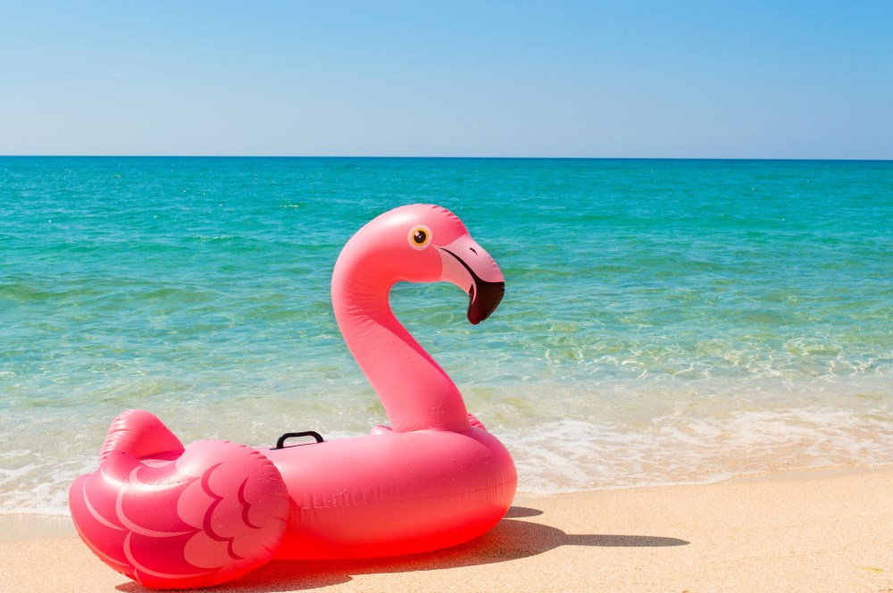 Pink inflatable Flamingo on the beach