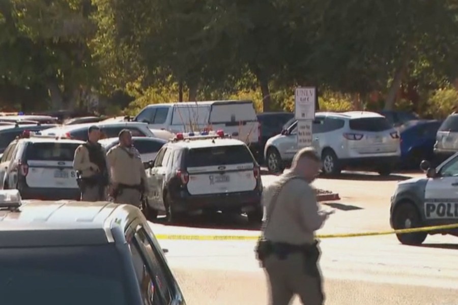 Officers work at the scene of a shooting