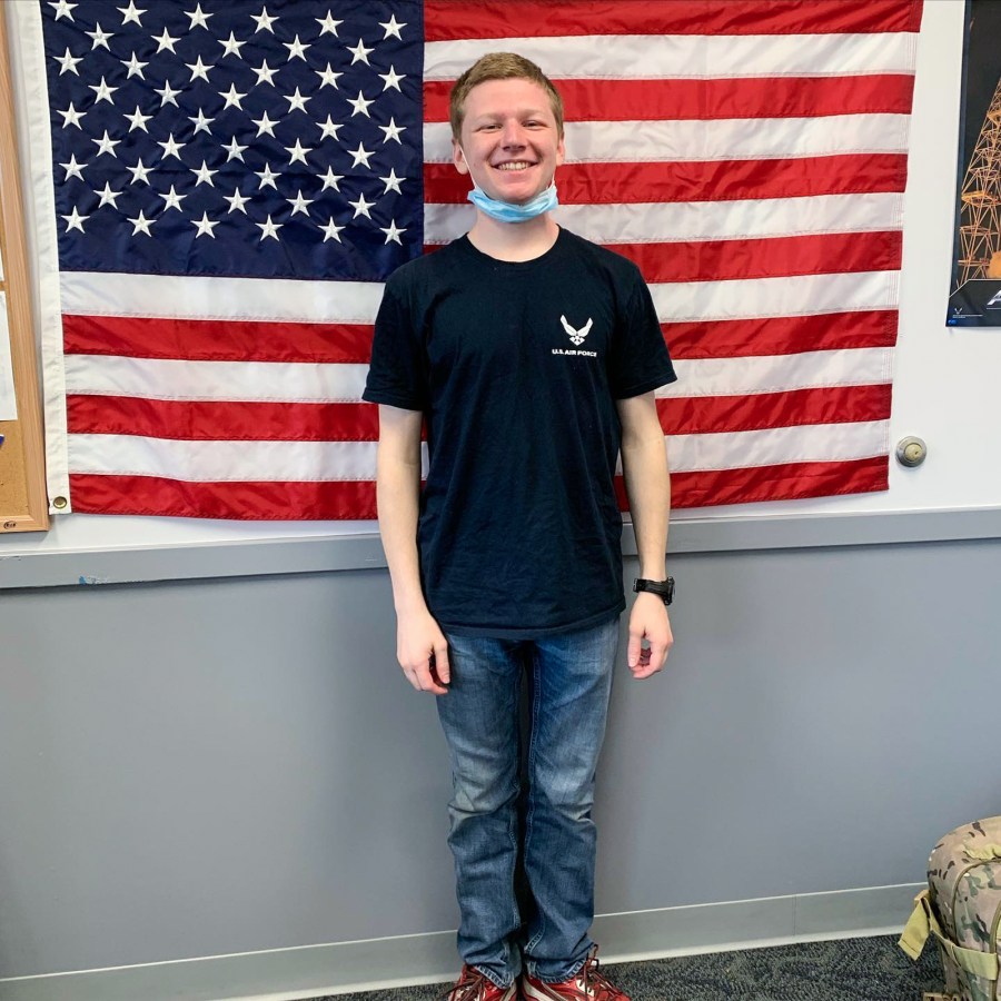 Aaron Bushnell in front of American flag