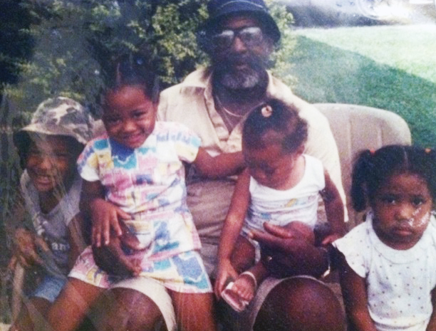 Childhood photo of Amira Barger, second from left, posing for a photo with her grandfather and her siblings 
