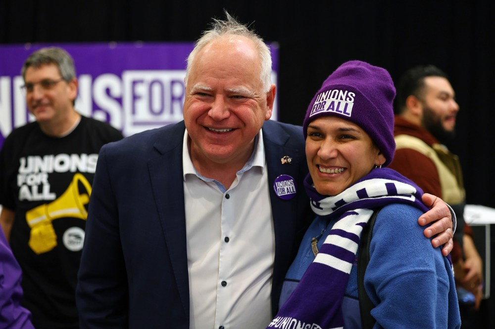 Minnesota Gov. Tim Walz speaks with union organizers before they march on businesses in downtown Minneapolis on Oct. 14, 2022.