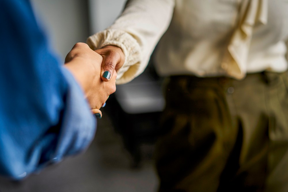 Businesswomen shaking hands in conference room