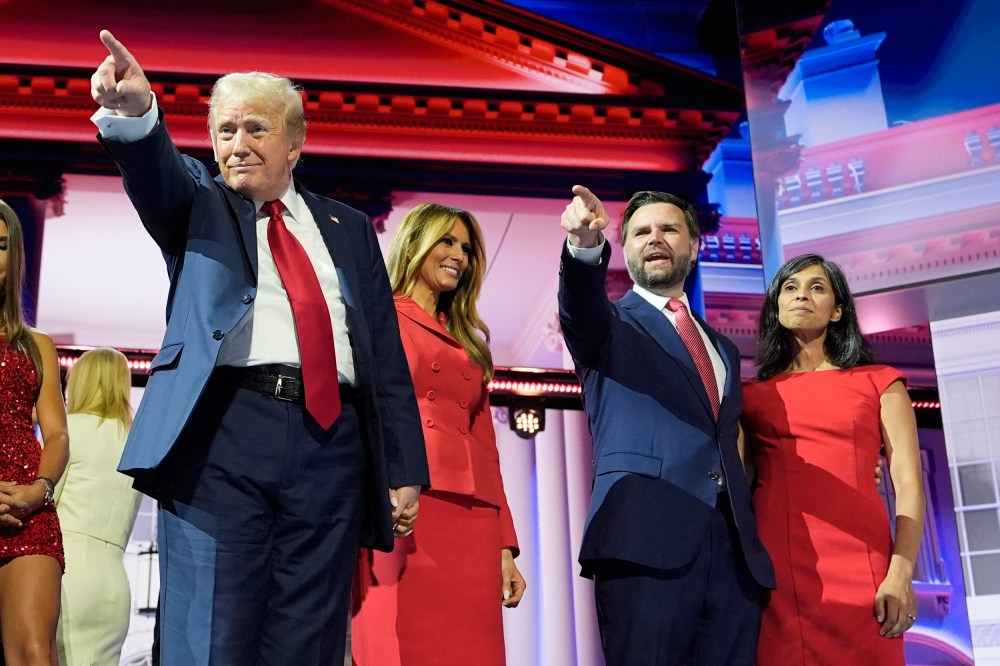 Former President Donald Trump stands on stage with Melania Trump, Sen. JD Vance, R-Ohio, and his wife Usha Chilukuri Vance