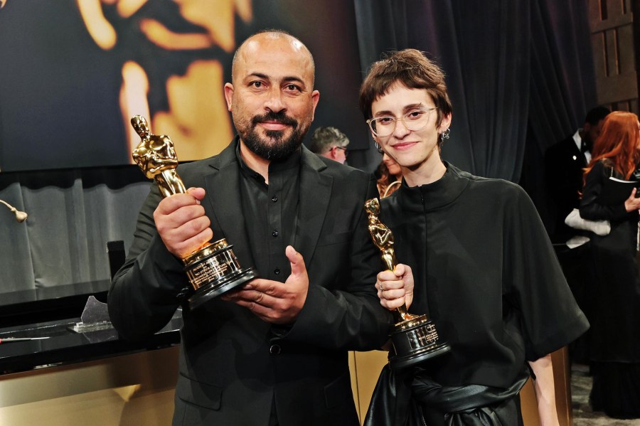 Hamdan Ballal and Rachel Szor hold their Oscars for 