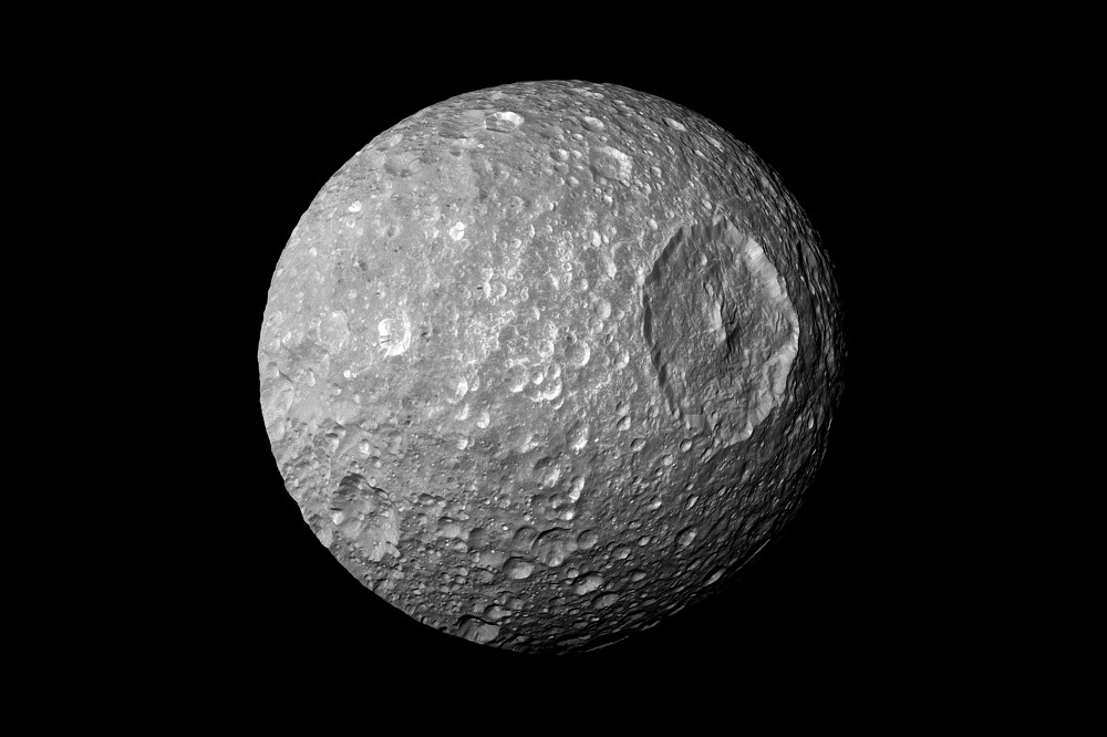 In this view captured by NASA's Cassini spacecraft on its closest-ever flyby of Saturn's moon Mimas, large Herschel Crater dominates Mimas, making the moon look like the Death Star in the movie "Star Wars."