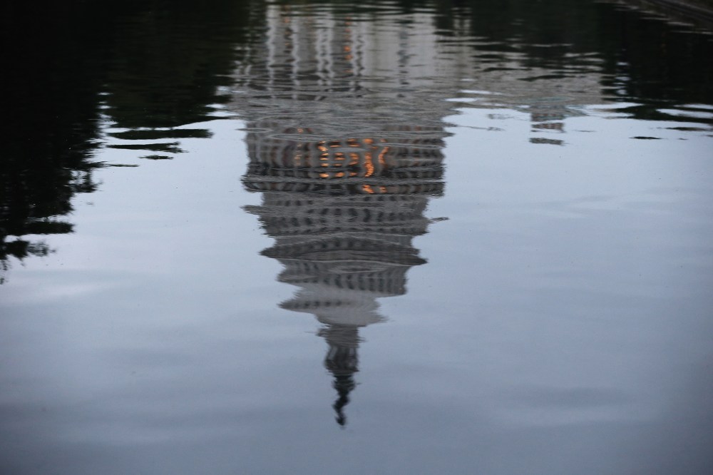 The U.S. Capitol is reflected in water on the morning of June 11, 2014 in Washington, DC.