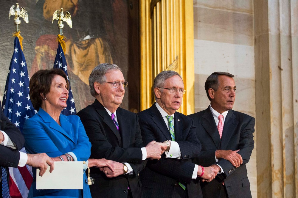 Lawmakers lock arms as they sing 'We Shall Overcome' during a ceremony to posthumously award the Congressional Gold Medal Dr. Martin Luther King, Jr. and Coretta Scott King, on Capitol Hill, June 24, 2014.