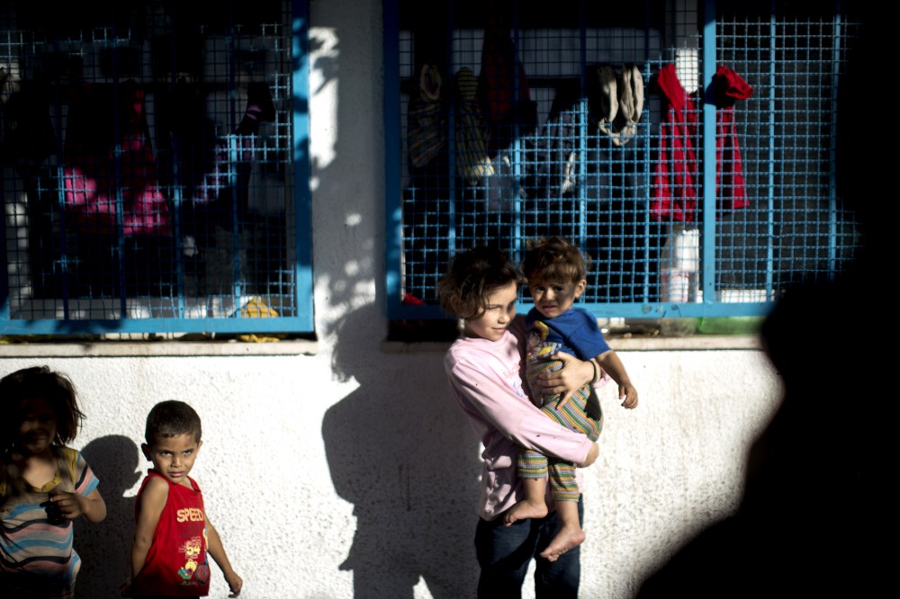 Palestinian children take refuge at a UN school after evacuating their homes near the border at the Jabaliya refugee camp in the Gaza Strip on July 15, 2014.