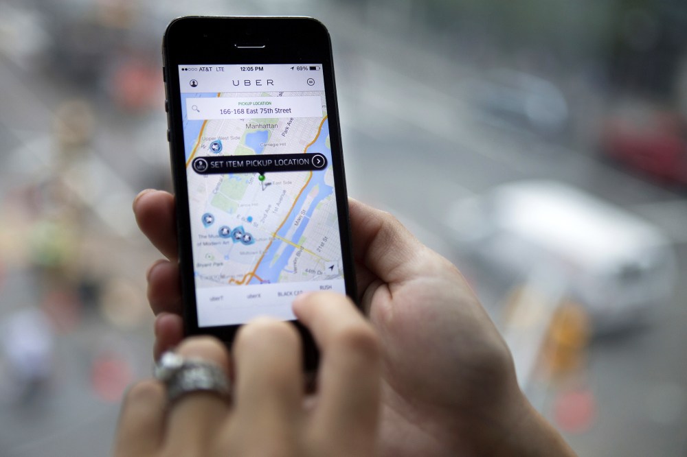 Th Uber Technologies Inc. car service application is demonstrated for a photograph on an iPhone in New York, N.Y., on Aug. 6, 2014. (Photo by Victor J. Blue/Bloomberg/Getty)
