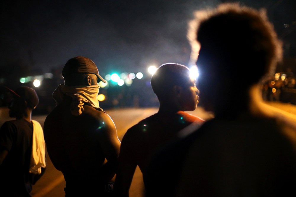 Demonstrators protest the killing of teenager Michael Brown on Aug. 12, 2014 in Ferguson, Mo.