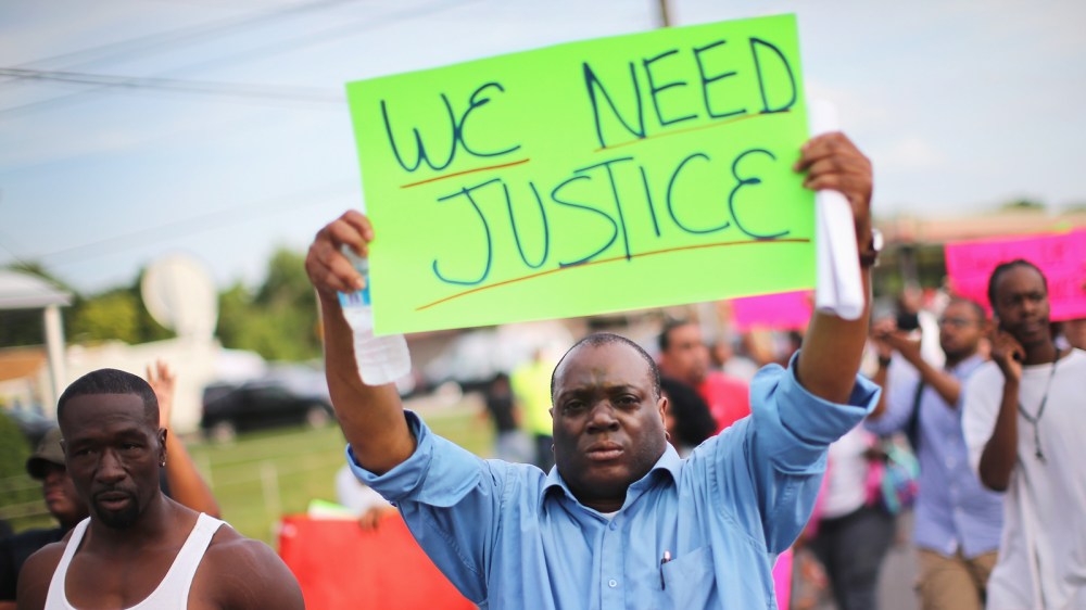 Demonstrators protest the shooting death of teenager Michael Brown on August 14, 2014 in Ferguson, Missouri.