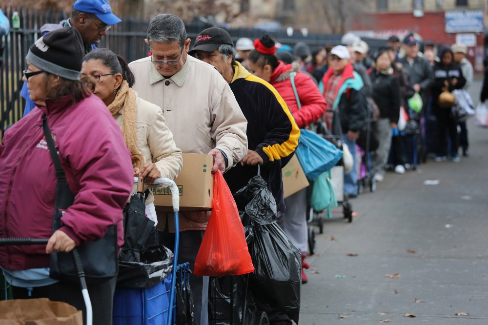 Brooklyn residents receive free food as part of a Bowery Mission outreach program on December 5, 2013 in the Brooklyn borough of New York City.
