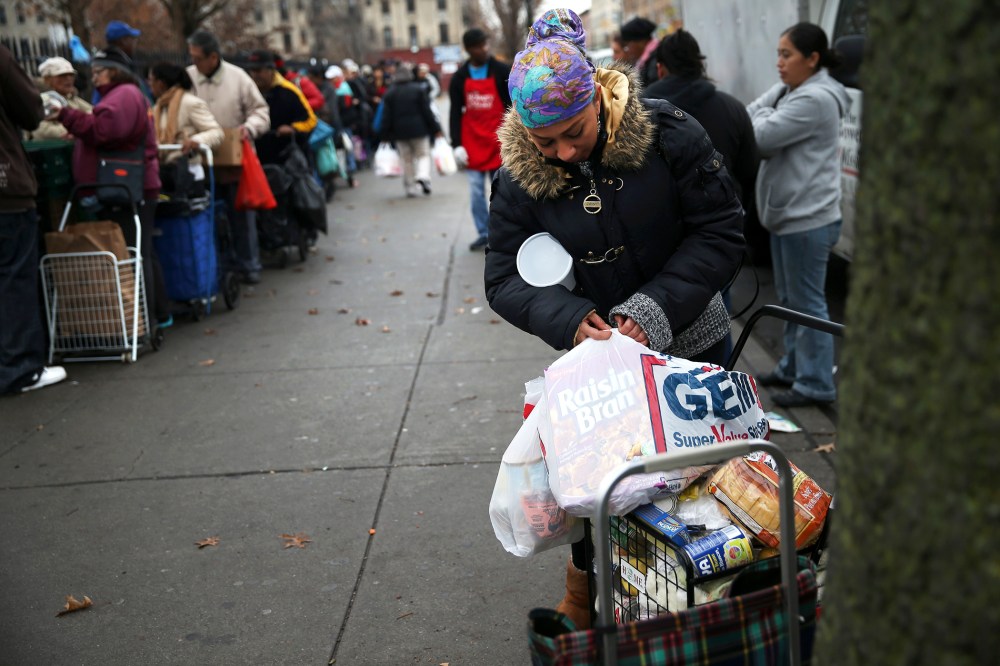 Brooklyn residents receive free food as part of a Bowery Mission outreach program on December 5, 2013.