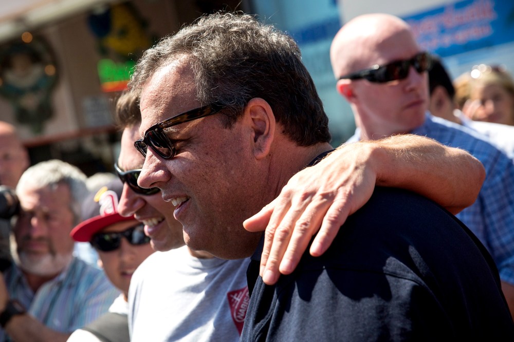 New Jersey Governor Chris Christie takes a photo with a fan while touring the boardwalk on August 29, 2014 in Point Pleasant, New Jersey.