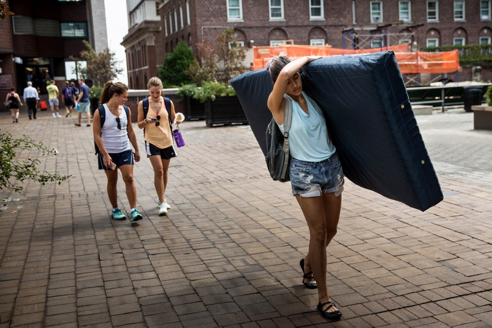 Emma Sulkowicz, a senior visual arts student at Columbia University, carries a mattress in protest of the university's lack of action after she reported being raped during her sophomore year on Sep. 5, 2014 in New York City. (Photo by Andrew Burton/Getty)