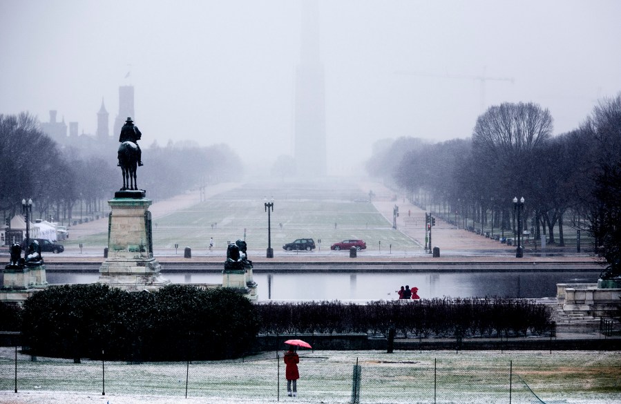A woman holds an umbrella at the U.S. Capitol on December 10, 2013 in Washington, DC.