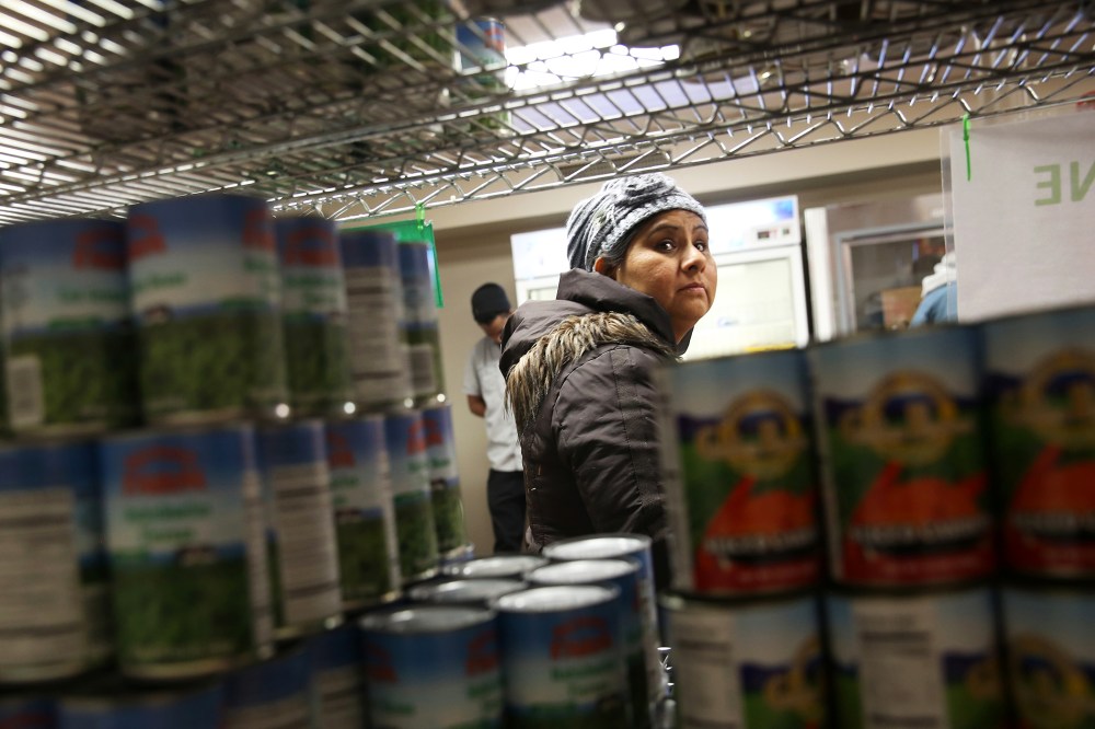 A Harlem resident chooses free groceries at the Food Bank For New York City, Dec. 11, 2013.