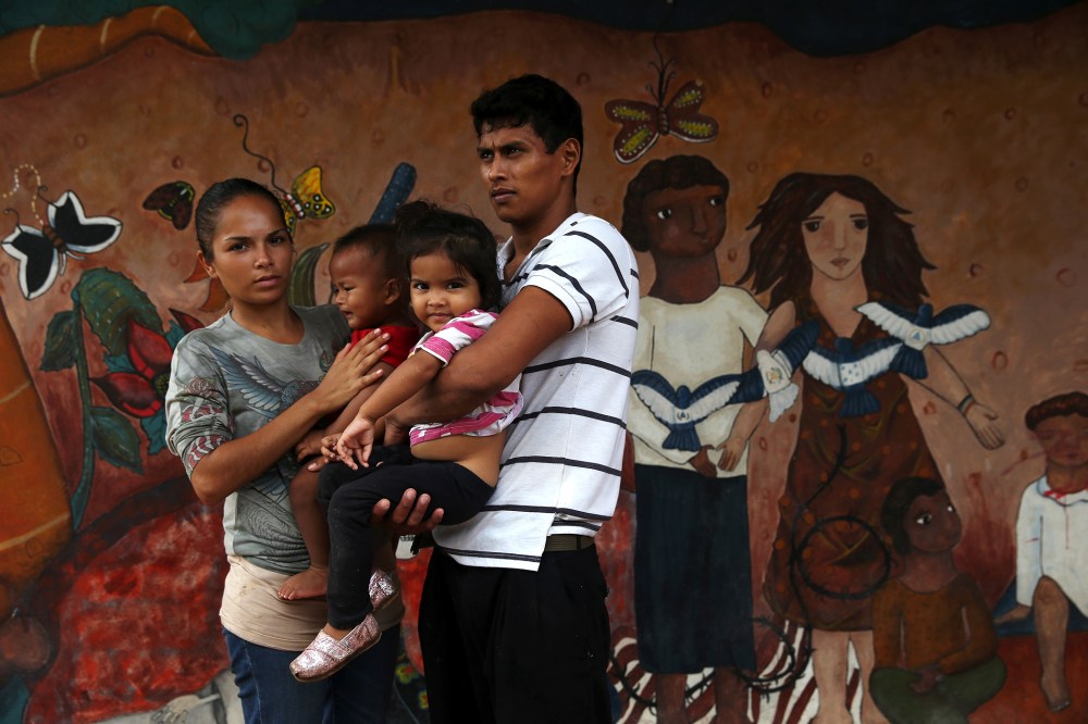 A family of immigrants arrives from Honduras to a shelter for undocumented immigrants on September 15, 2014 in Tenosique, Mexico.