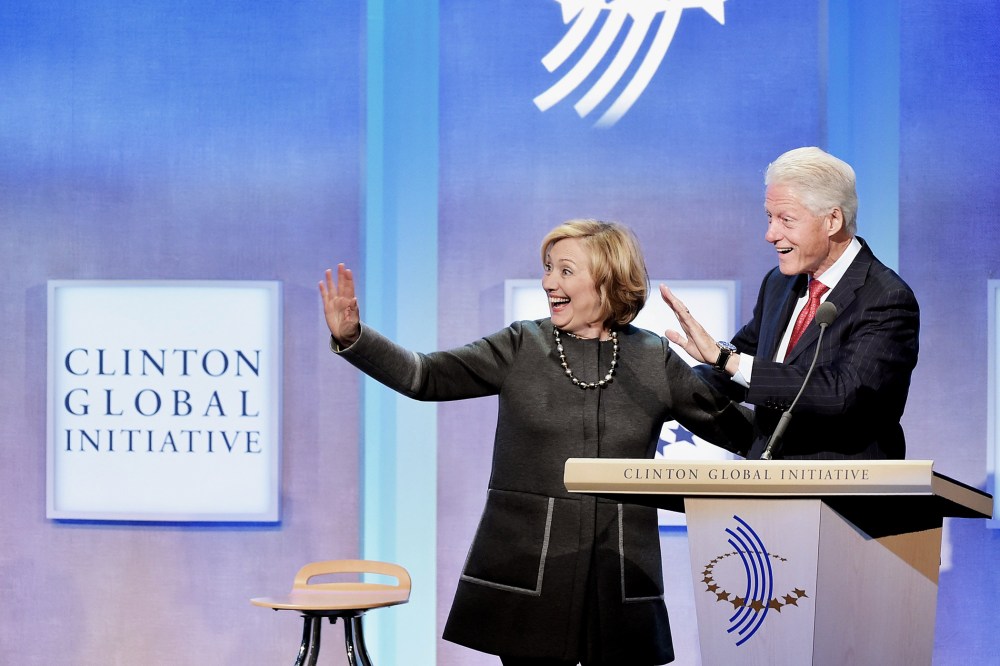 Former US Secretary of State Hillary Clinton and husband, Former U.S. President Bill Clinton address the audience during a meeting for the Clinton Global Initiative on Sept. 22, 2014 in New York City.